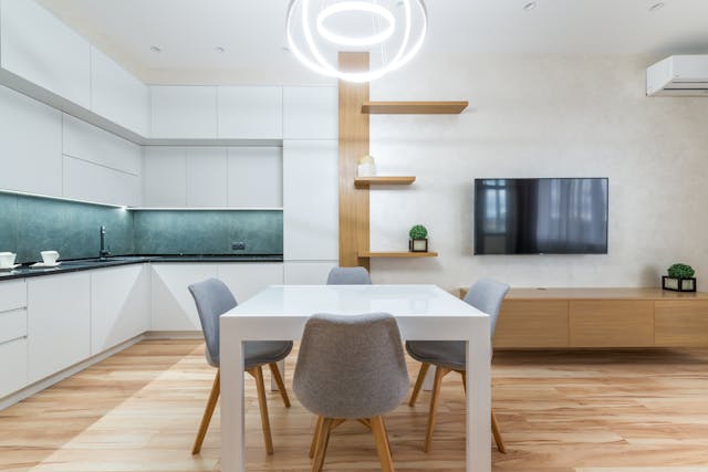 house-with-table-with-chairs-near-tv-and-open-kitchen